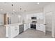 Bright and stylish kitchen featuring a center island, stainless appliances, and modern lighting at 3749 Sw 131St St, Ocala, FL 34473