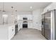 Well-equipped kitchen with stainless steel appliances, white cabinets, and sleek countertops at 3749 Sw 131St St, Ocala, FL 34473