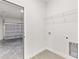 Functional laundry room with a garage view, featuring essential hookups and a sleek design at 3749 Sw 131St St, Ocala, FL 34473