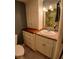 Cozy bathroom featuring vanity cabinet with drawers, decorative mirror, and neutral-toned wall paint at 400 E Colonial Dr # 910, Orlando, FL 32803