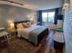 Bright bedroom features wood floors, a big window with city views and an area for a desk at 400 E Colonial Dr # 910, Orlando, FL 32803