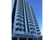 Exterior low angle view of Park Lake Towers shows multiple floors with balconies on a sunny day at 400 E Colonial Dr # 910, Orlando, FL 32803