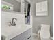 Bathroom featuring gray vanity, sink, faucet, and a toilet at 4015 Ibis Dr, Orlando, FL 32803