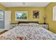 Bedroom featuring hardwood floors, yellow walls, ceiling fan, and bed at 4015 Ibis Dr, Orlando, FL 32803