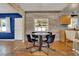 Cozy dining area with wood floors and walls, and a window looking to the back yard at 4015 Ibis Dr, Orlando, FL 32803