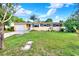 A single-story home featuring a well-manicured lawn, a garage, and decorative window shutters at 4015 Ibis Dr, Orlando, FL 32803