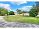 A single-story home with a well-manicured lawn, mature trees, and a paved sidewalk at 4015 Ibis Dr, Orlando, FL 32803