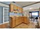 Functional kitchen with wooden cabinets, an electric cooktop, and access to the dining area at 4015 Ibis Dr, Orlando, FL 32803