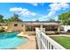 Backyard pool with a view of the enclosed sunroom, and lawn area under a blue sky with clouds at 4015 Ibis Dr, Orlando, FL 32803