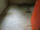 Spacious, bare room, featuring discolored, damaged flooring at 4231 Raleigh St, Orlando, FL 32811