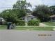 Charming bungalow with overgrown landscaping and lush foliage along the front at 4231 Raleigh St, Orlando, FL 32811