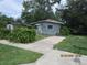 Front yard view of the single-story home, showcasing mature landscaping at 4231 Raleigh St, Orlando, FL 32811