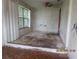 Empty living room featuring damaged floors and walls, awaiting renovation at 4231 Raleigh St, Orlando, FL 32811