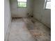 Damaged room showing unfinished floors, awaiting renovation or customization at 4231 Raleigh St, Orlando, FL 32811