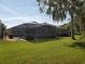 Expansive backyard featuring a screened lanai perfect for outdoor living and entertaining at 4351 Winding Oaks Cir, Mulberry, FL 33860