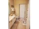 Bathroom featuring a vanity, toilet, tile flooring, and a shuttered exterior door at 4351 Winding Oaks Cir, Mulberry, FL 33860