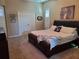 Cozy bedroom features a comfortable bed, plantation shutters, and an adjacent room that can be used as a home office at 4351 Winding Oaks Cir, Mulberry, FL 33860
