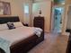 Comfortable bedroom with carpet, nautical decor, and a connecting bathroom doorway at 4351 Winding Oaks Cir, Mulberry, FL 33860