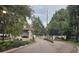 Gated entrance to a community with lush landscaping at 4351 Winding Oaks Cir, Mulberry, FL 33860