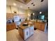 The kitchen has an island, granite countertops, light wood cabinets, and modern appliances at 4351 Winding Oaks Cir, Mulberry, FL 33860