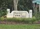 Community sign for Fairway Oaks with lush landscaping at 4351 Winding Oaks Cir, Mulberry, FL 33860