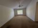 Large, airy carpeted bedroom features a ceiling fan, neutral walls, and lots of natural light at 436 Hammerstone Ave, Haines City, FL 33844