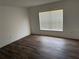 Well lit bedroom with luxury vinyl plank flooring and bright window with blinds at 436 Hammerstone Ave, Haines City, FL 33844