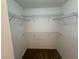 Empty walk-in closet with carpeted floor and metal shelving for ample storage at 436 Hammerstone Ave, Haines City, FL 33844