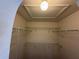 Spacious walk-in closet with lighting and shelving for lots of efficient storage at 436 Hammerstone Ave, Haines City, FL 33844