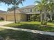 Inviting two-story home featuring an attached two-car garage and a well-manicured lawn at 436 Hammerstone Ave, Haines City, FL 33844