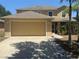 Inviting two-story home featuring an attached two-car garage and a well-manicured lawn at 436 Hammerstone Ave, Haines City, FL 33844