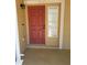 Welcoming front door with sidelight window, exterior lighting and view of front porch at 436 Hammerstone Ave, Haines City, FL 33844