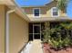 Inviting front porch with colorful garden bed at 436 Hammerstone Ave, Haines City, FL 33844