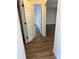 View from hallway showing new hardwood floors, white trim and paint, and a door on hinges at 436 Hammerstone Ave, Haines City, FL 33844
