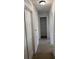 Hallway with carpet flooring leading to closet at 436 Hammerstone Ave, Haines City, FL 33844