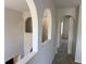 Hallway with decorative arches and neutral carpeting at 436 Hammerstone Ave, Haines City, FL 33844