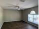 A living room featuring wood-look flooring and large window at 436 Hammerstone Ave, Haines City, FL 33844