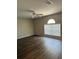 Living room featuring wood-look flooring and large window at 436 Hammerstone Ave, Haines City, FL 33844