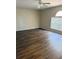 A living room featuring wood-look flooring and a ceiling fan at 436 Hammerstone Ave, Haines City, FL 33844