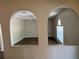 Living room viewed through decorative arches with wood-look flooring at 436 Hammerstone Ave, Haines City, FL 33844