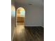 Bright living room features hardwood floors and an arched entry to the kitchen area at 436 Hammerstone Ave, Haines City, FL 33844
