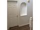 Upstairs hallway with closet niche, white paint and trim, and hardwood-look vinyl flooring at 436 Hammerstone Ave, Haines City, FL 33844