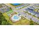 Aerial view of community amenities including pool, playground, sports field, and nearby homes at 4530 Narrative Ln, Kissimmee, FL 34746