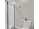 Modern bathroom featuring a glass-enclosed shower and white toilet at 4530 Narrative Ln, Kissimmee, FL 34746