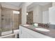 Bathroom showcasing a double vanity, a large mirror, and glass-enclosed shower at 4530 Narrative Ln, Kissimmee, FL 34746