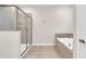 Well-lit bathroom with glass-enclosed shower and separate soaking tub at 4530 Narrative Ln, Kissimmee, FL 34746