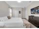 Comfortable bedroom with a luxurious bed, dresser, and modern entertainment setup at 4530 Narrative Ln, Kissimmee, FL 34746