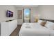 Bedroom featuring a queen bed, white dresser, TV and modern decor at 4530 Narrative Ln, Kissimmee, FL 34746