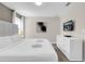 Comfortable bedroom with a plush bed, white linens, and a wall-mounted television at 4530 Narrative Ln, Kissimmee, FL 34746