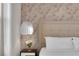 Cozy bedroom with floral wallpaper, a plush bed, and natural light at 4530 Narrative Ln, Kissimmee, FL 34746